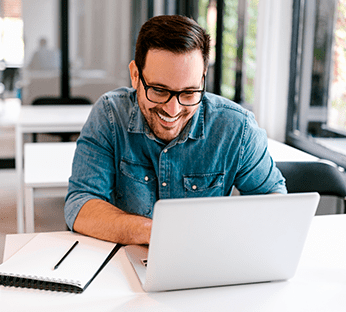 Homem trabalha com notebook no escritório